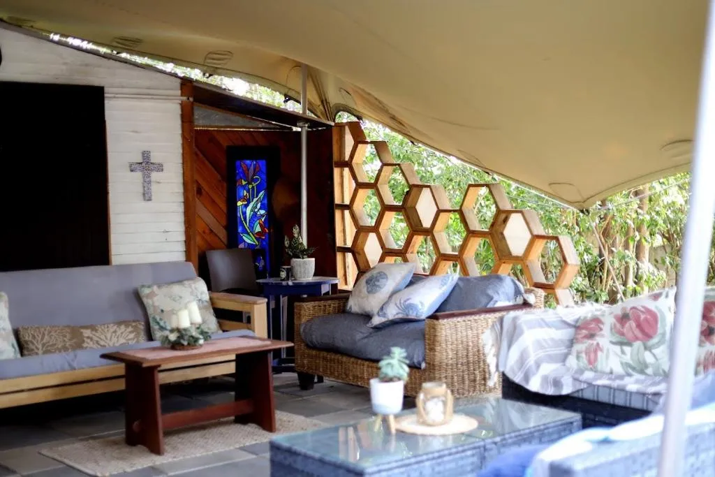 The lapa lounge under canvas, with stained glass and garden views
